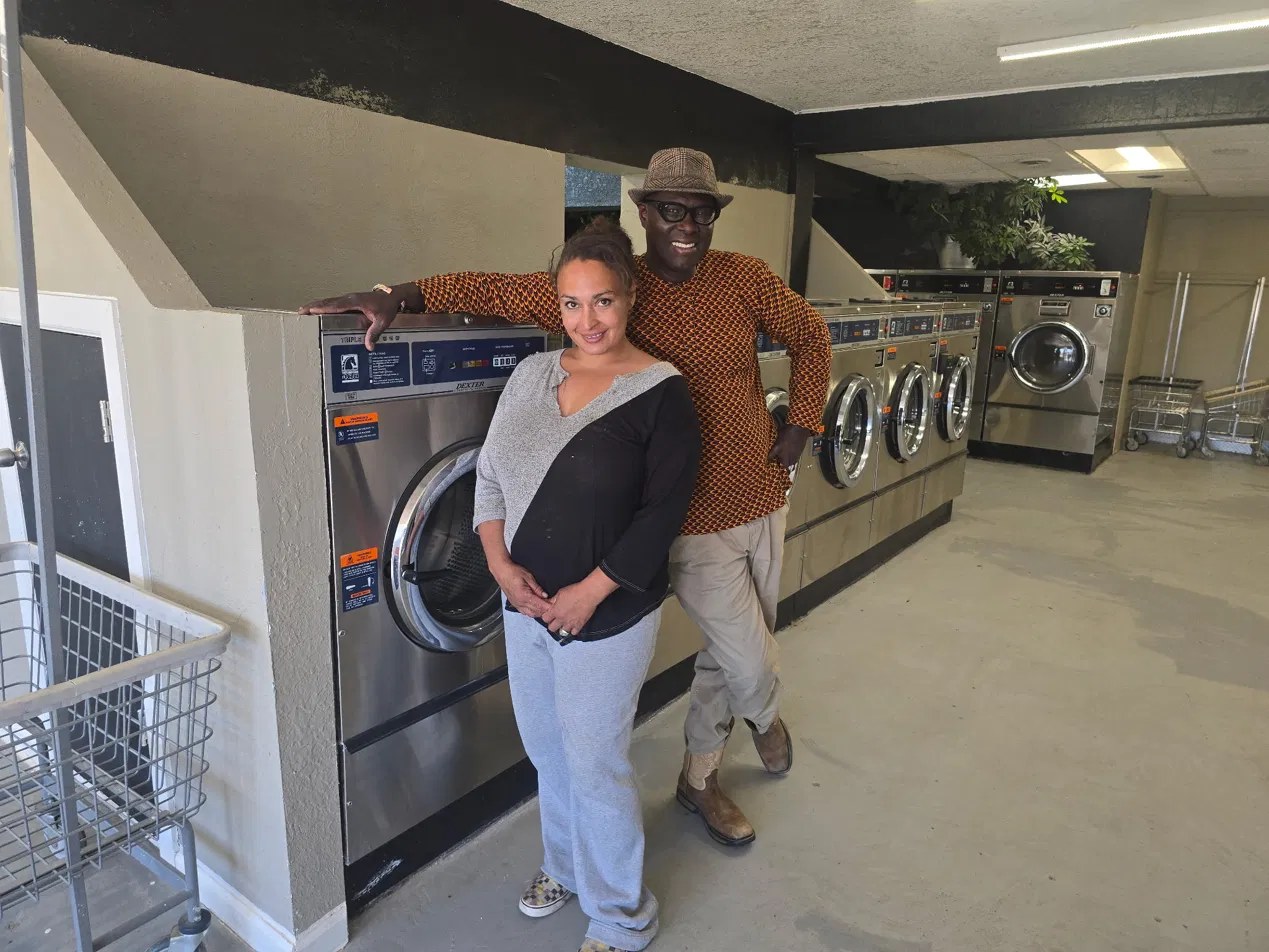 Yemane Habtezgi and team member inside the laundromat